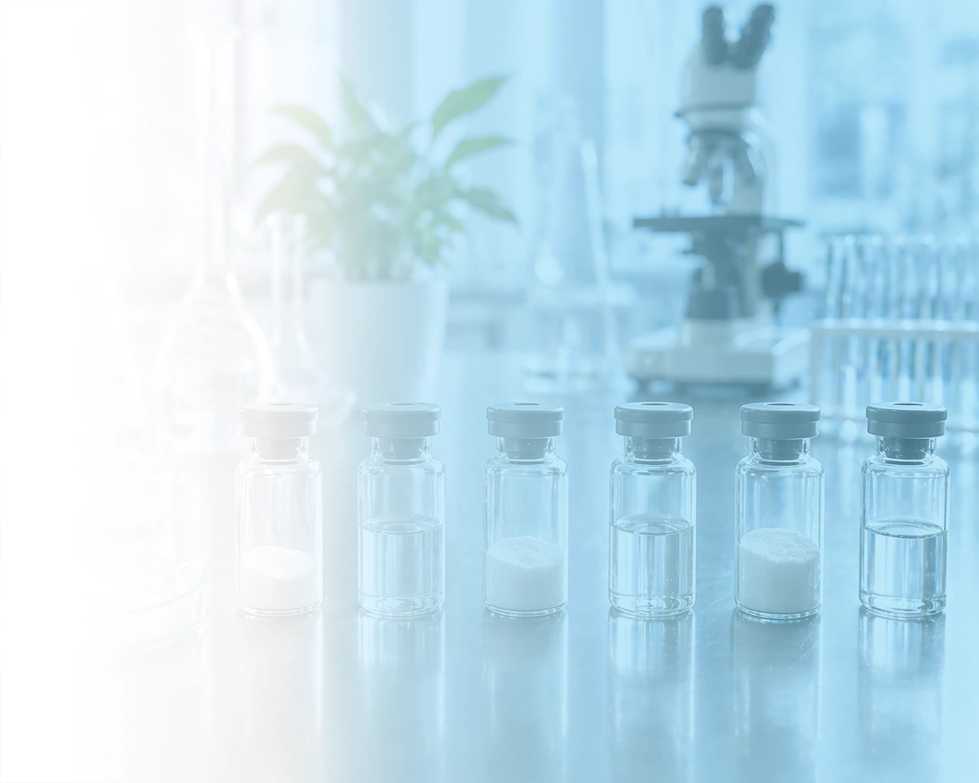 Clean laboratory scene with glass vials and clinical formulation materials